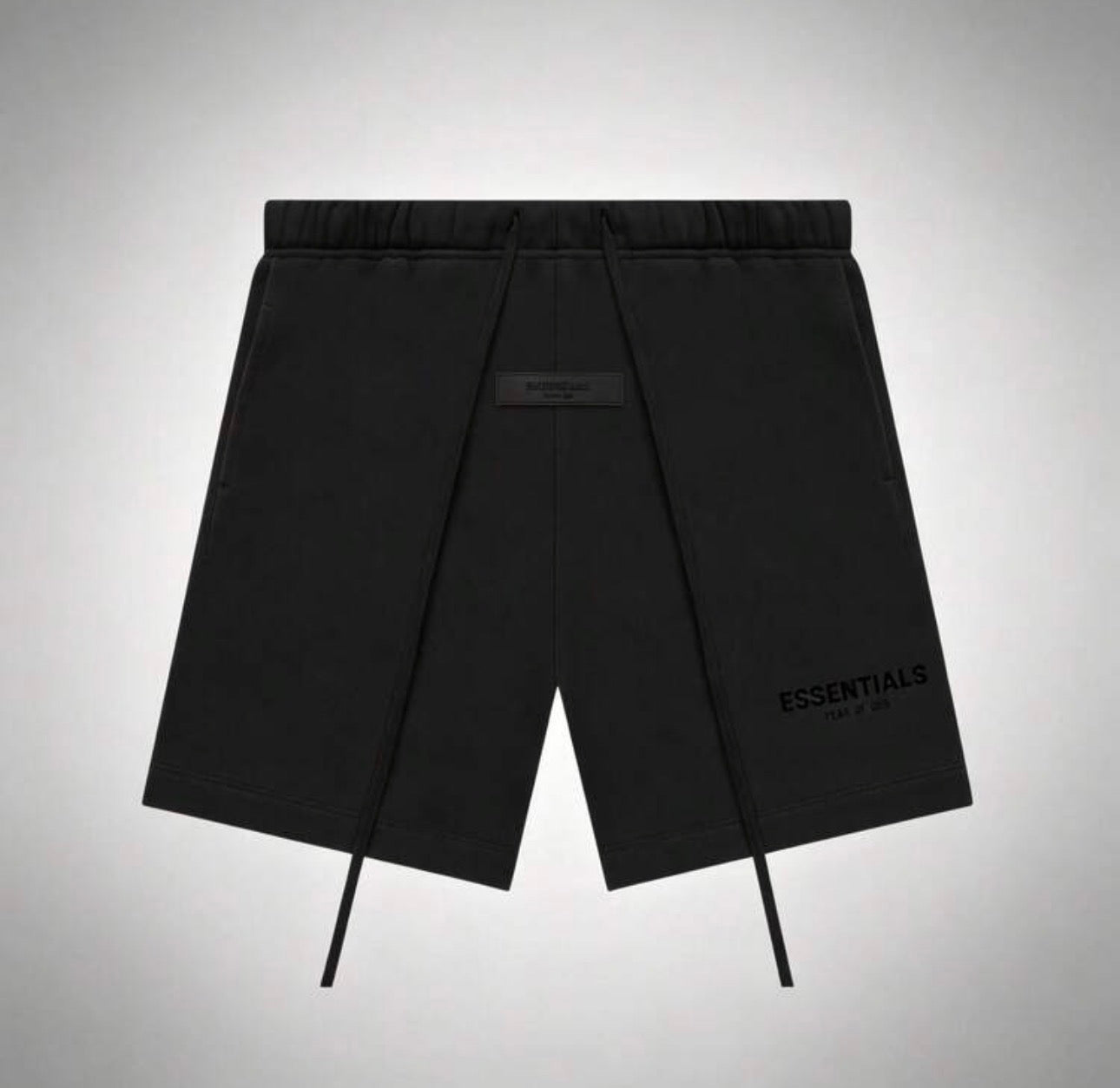 Black Off-White Essentials drawstring shorts with a tonal brand label at the center waist and 'ESSENTIALS FEAR OF GOD’