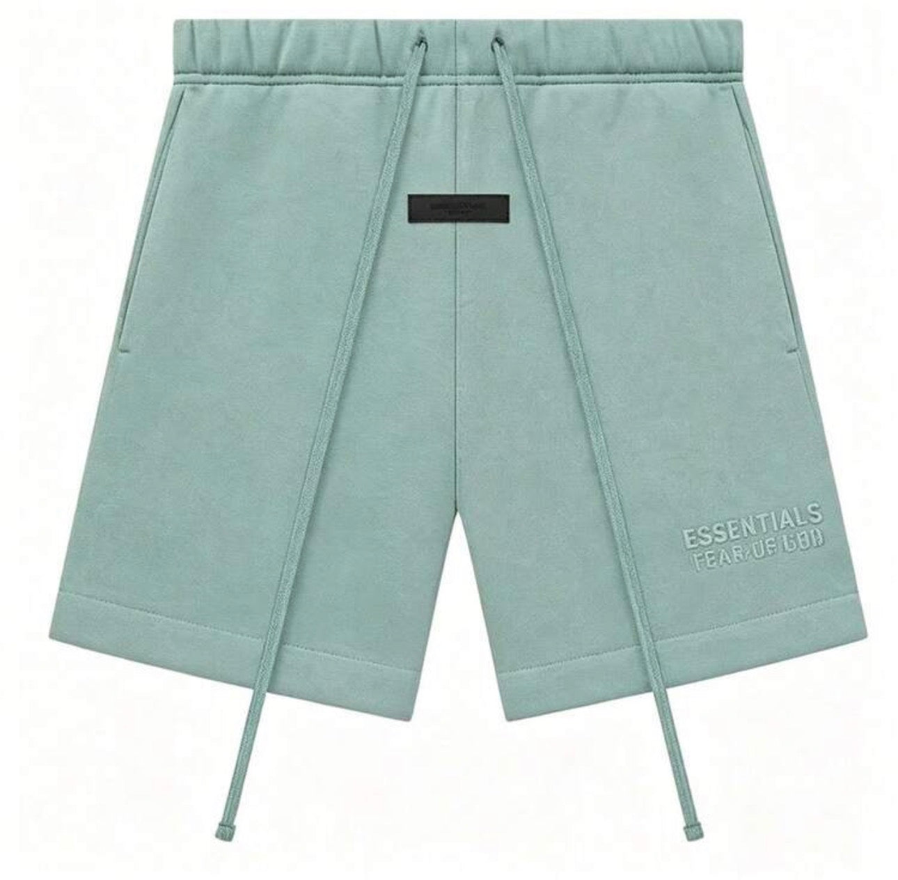 A pair of sage green sweat shorts with a drawstring waist, side pockets, and 'ESSENTIALS FEAR OF GOD'  